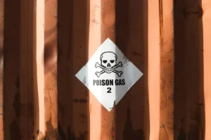 Hazardous label on a shipping container with a skull and cross bones labelled Poison Gas