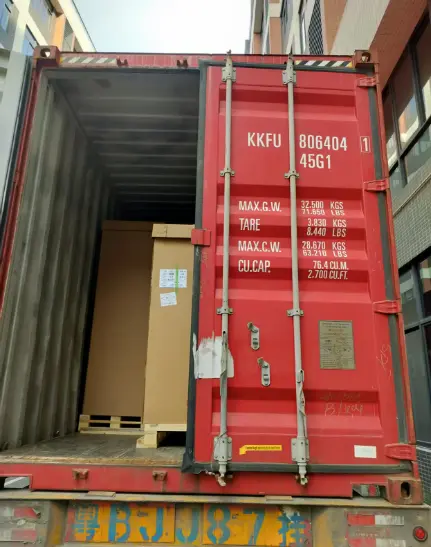 Open door on shipping container from China, loaded with pallets