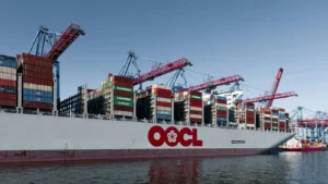 Large sea freight vessel docked at quay for loading and unloading of shipping containers