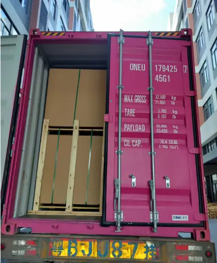 Pink Shipping Container from China, loaded with crated goods for sea freight